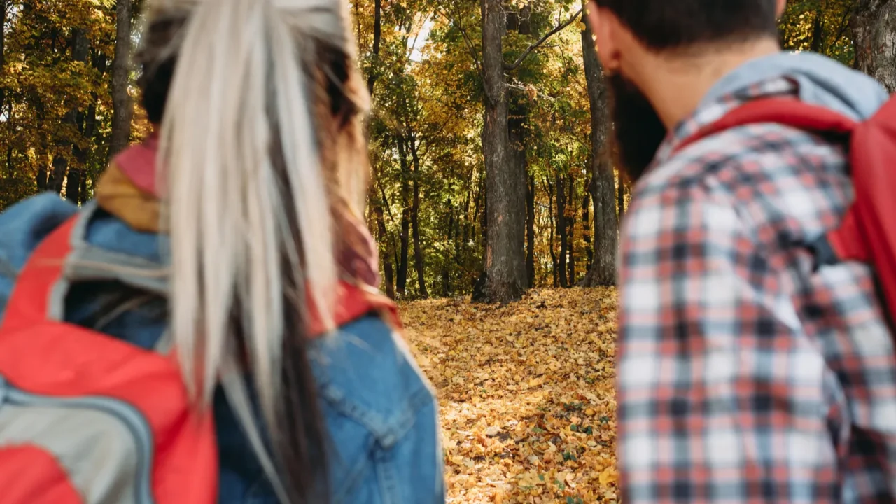 fall adventures couple backpacks autumn forest
