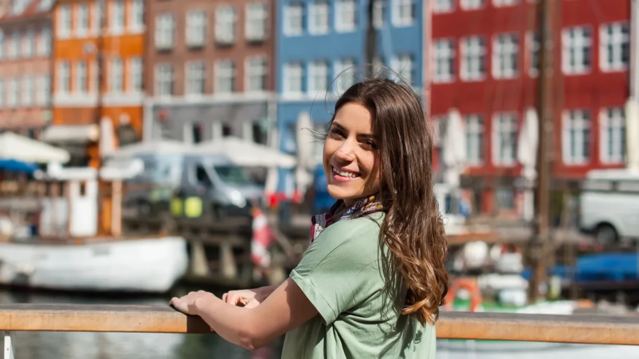 happy young tourist woman smiling at camera