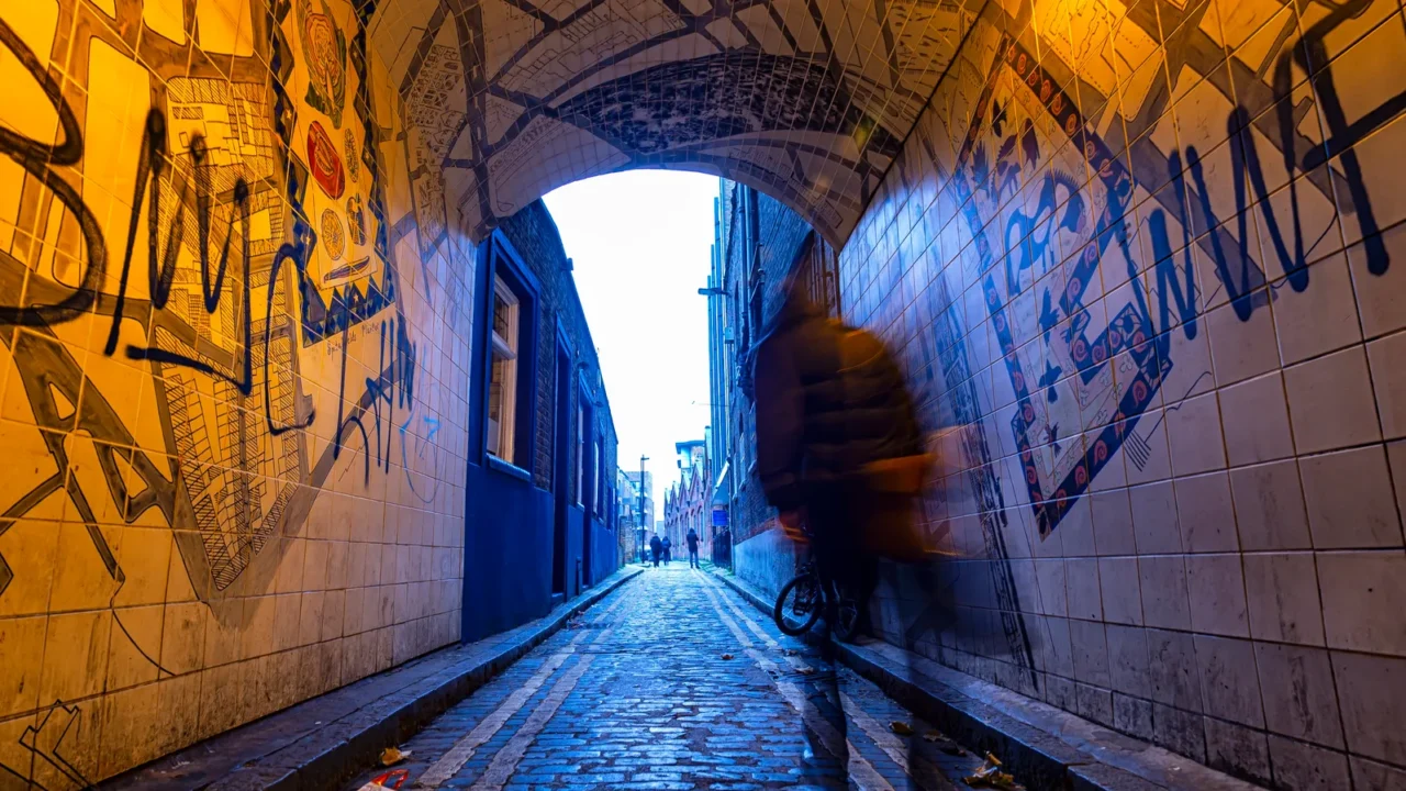 man walking in an alley of white chapel district