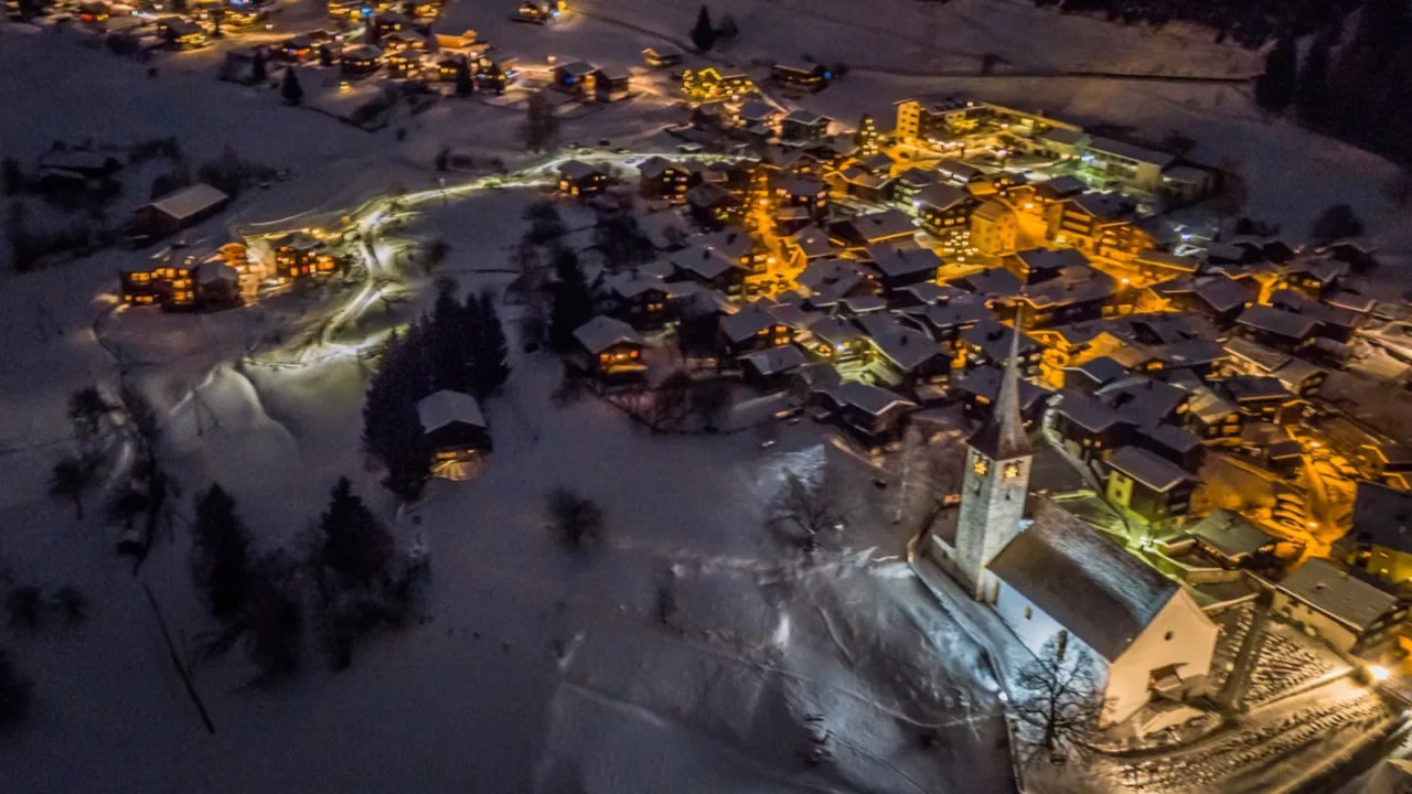 night aerial view of a swiss village on christmas