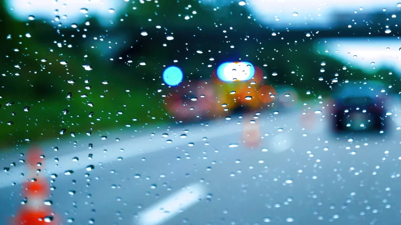 on a rainy day cars drive on the highway as