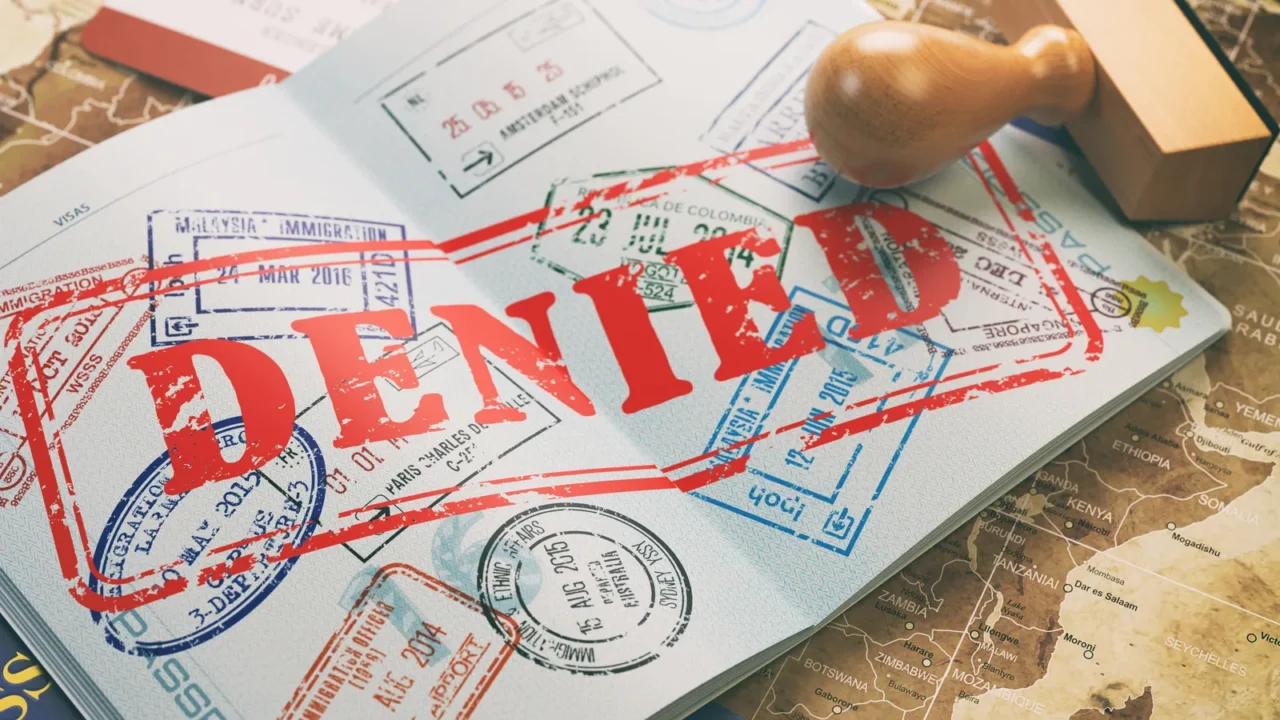 passport with denied visa stamp on the map of the