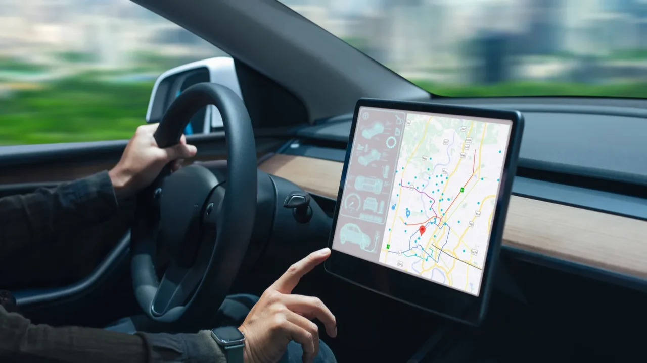 person driving a car while interacting with a modern touchscreen