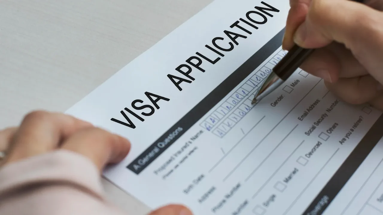 person holding pen and writing