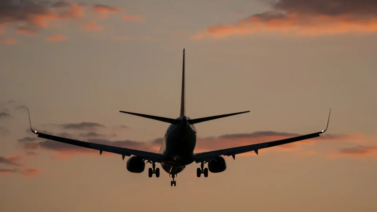 plane landing in a sunset