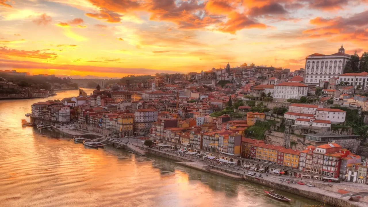 Panorama old city Porto at river Duoro,with Port transporting boats at sunset, Oporto, Portugal.