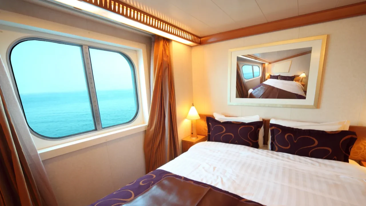 ship cabin with big double bed and window with view