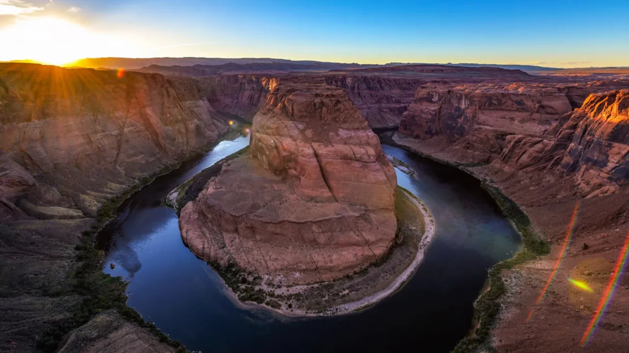 sunset over horseshoe bend and colorado river in coconino county