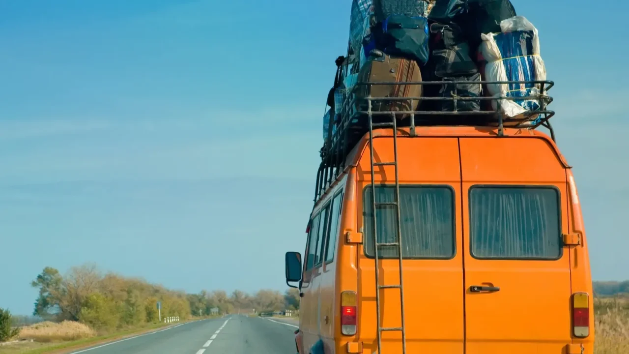 the small bus with bags on a roof