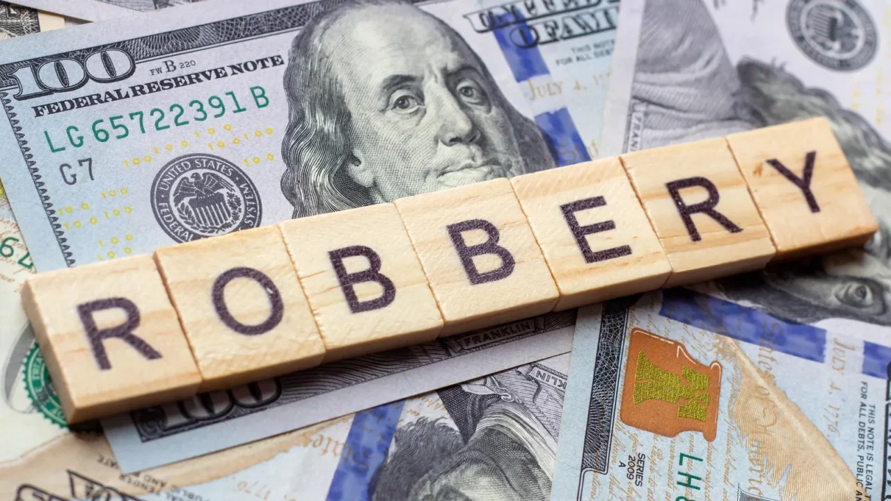 the word robbery on dollar usa background theft and stealing