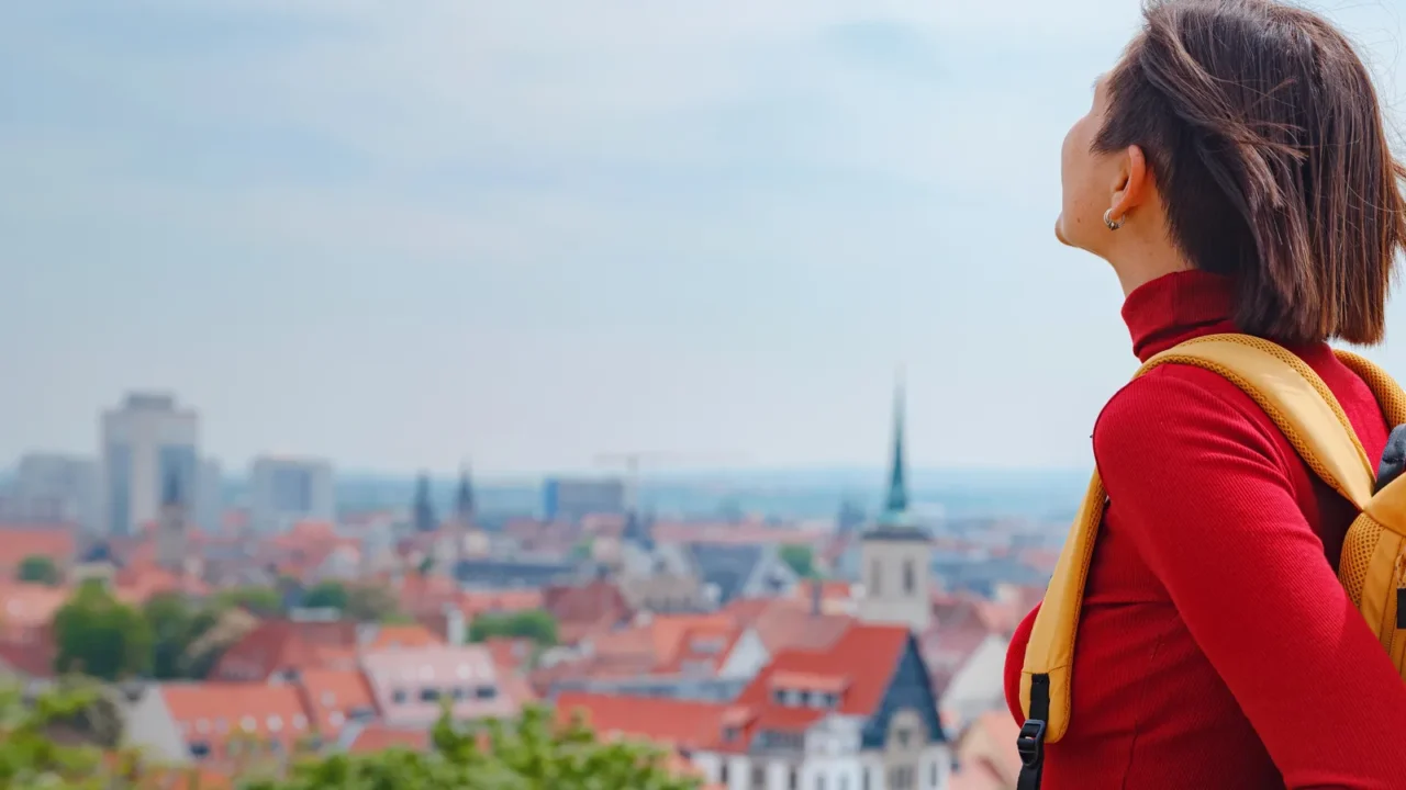 tourist woman explores beautiful city of erfurt wandering through its