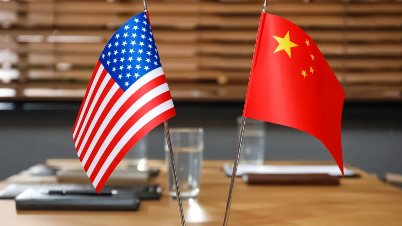 usa and china flags on wooden table in office international