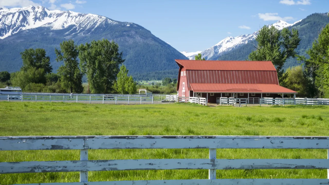 white fence and red barn in oregon