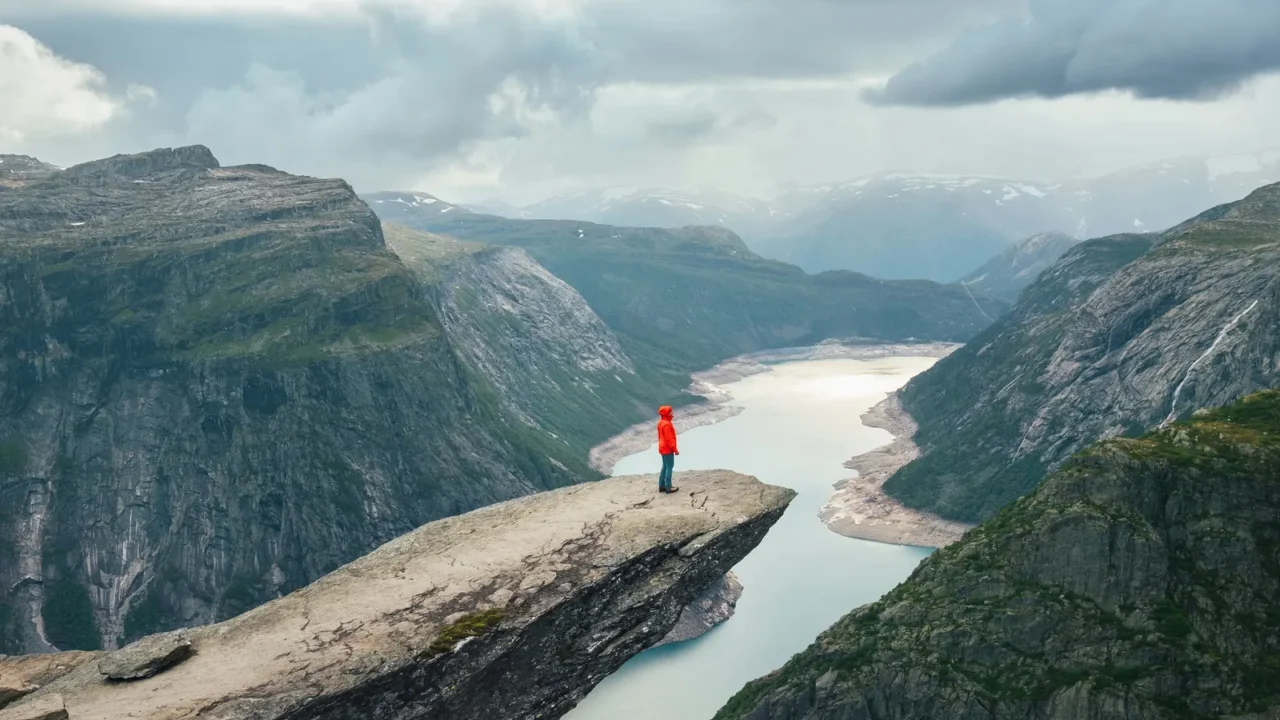 woman trekker dressed bright red jacket enjoying glacier ringedalsvatnet lake