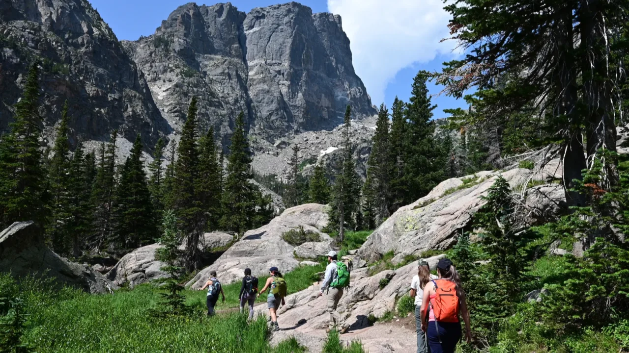 young hikers ascend emerald lake trail in rocky mountain natl