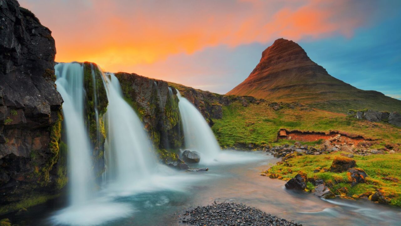 Kirkjufellsfoss and Kirkjufell (mountain), during sunset,