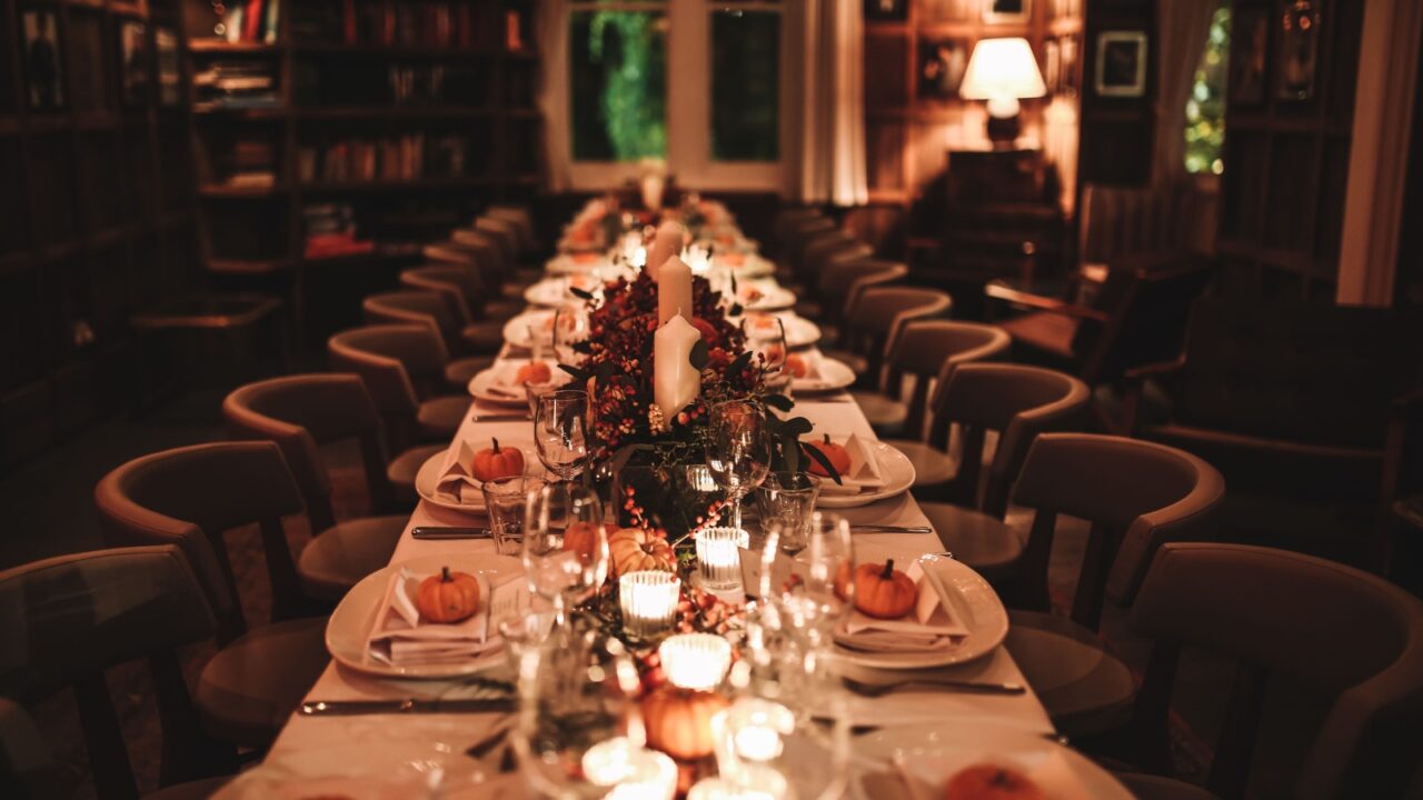 A beautiful table setting for Thanksgiving dinner in a restaurant. Private dining. Horizontal image, indoors, selective focus.