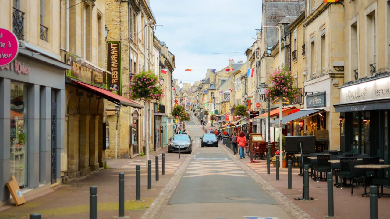 Bayeux, France - September 18 2023: The historic Rue Saint-Jean, the central pedestrian boulevard full of shops and cafes through the medieval center of Bayeux, France, October 3 2023.