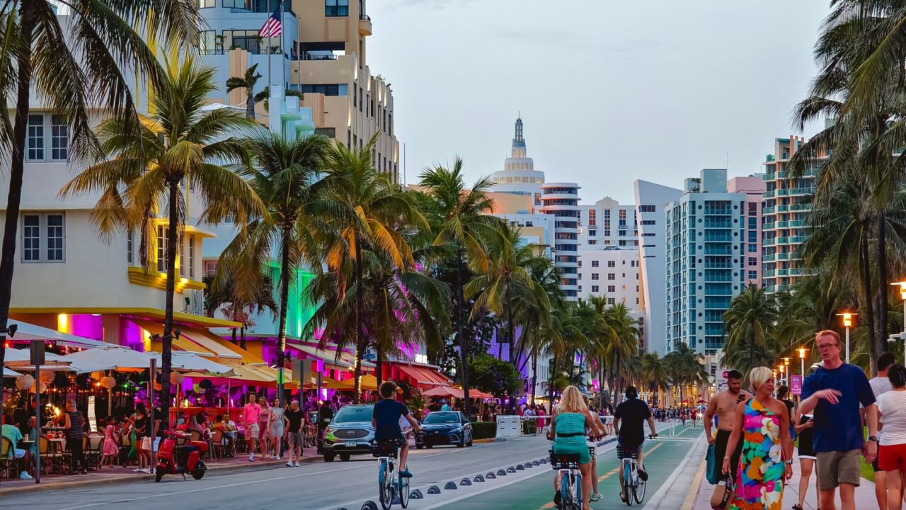 Miami Beach, Florida - July 8, 2024: People enjoying a vibrant evening at Ocean Drive in South Beach, Miami, with colorful buildings, palm trees, and lively atmosphere.