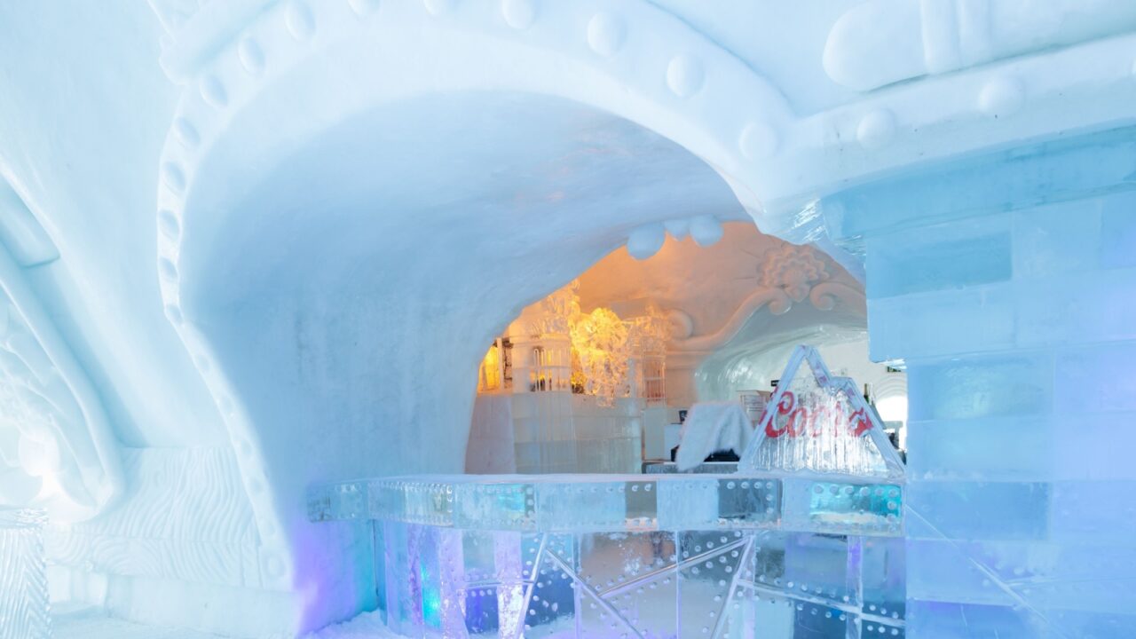 St-Gabriel-de-Valcartier, Quebec, Canada, March 1, 2023 - The bar in the world-renowned seasonal Ice Hotel illuminated in blue and gold