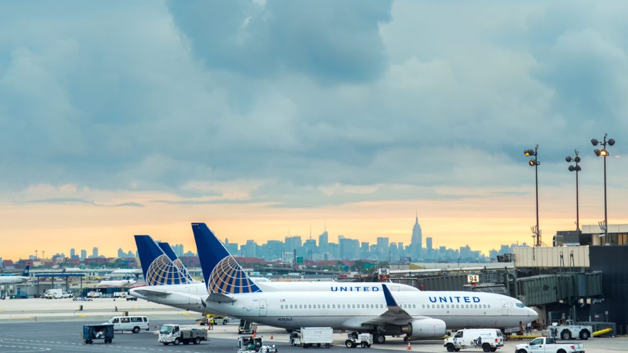 NEWARK, NJ - AUG 7: United Airlines plane on October 7, 2013 in Newark, NJ with NYC skyline in background. United Airlines merged with Continental in 2010 and is now the world's largest carrier.