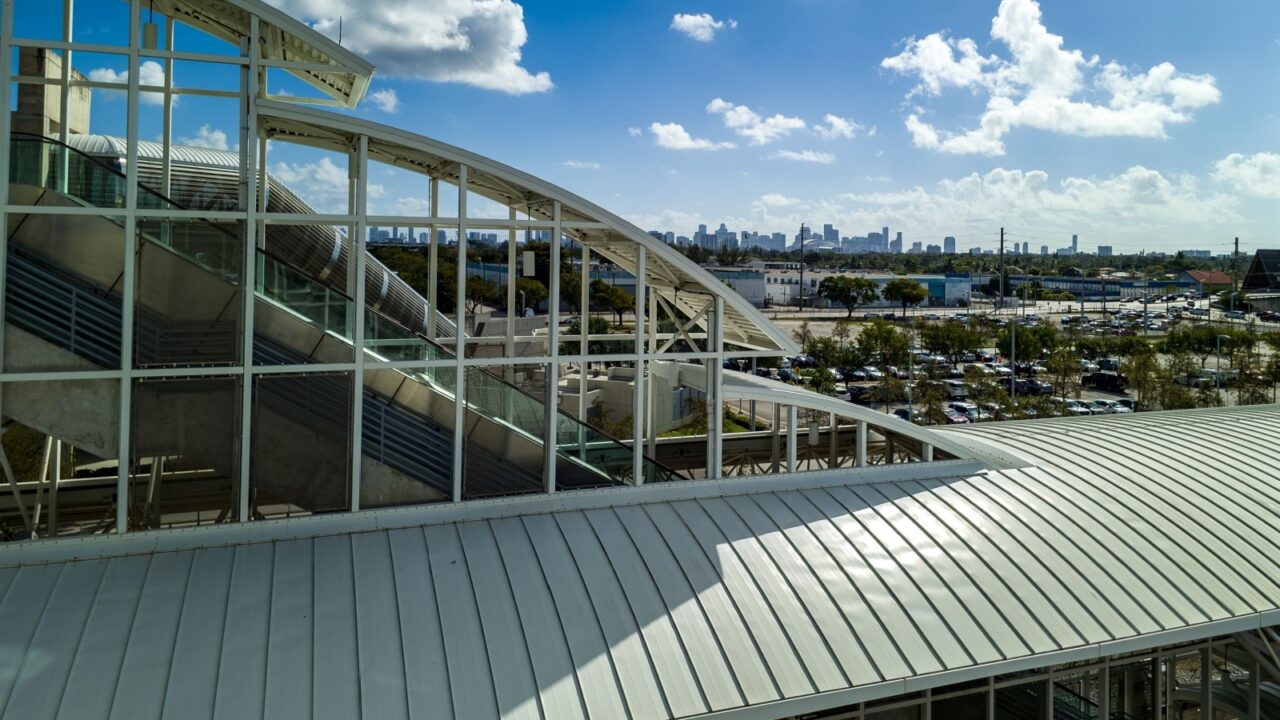 Miami, Florida, USA - February 15, 2025: Miami International Airport transportation center tri rail station escalators in Miami, Florida with view of Miami skyline cloudy day