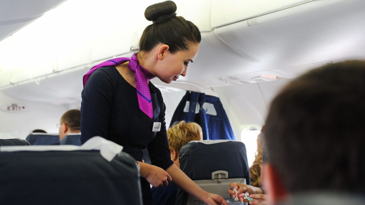Almaty, Kazakhstan - 05.06.2016 : A flight attendant checks passengers after boarding.