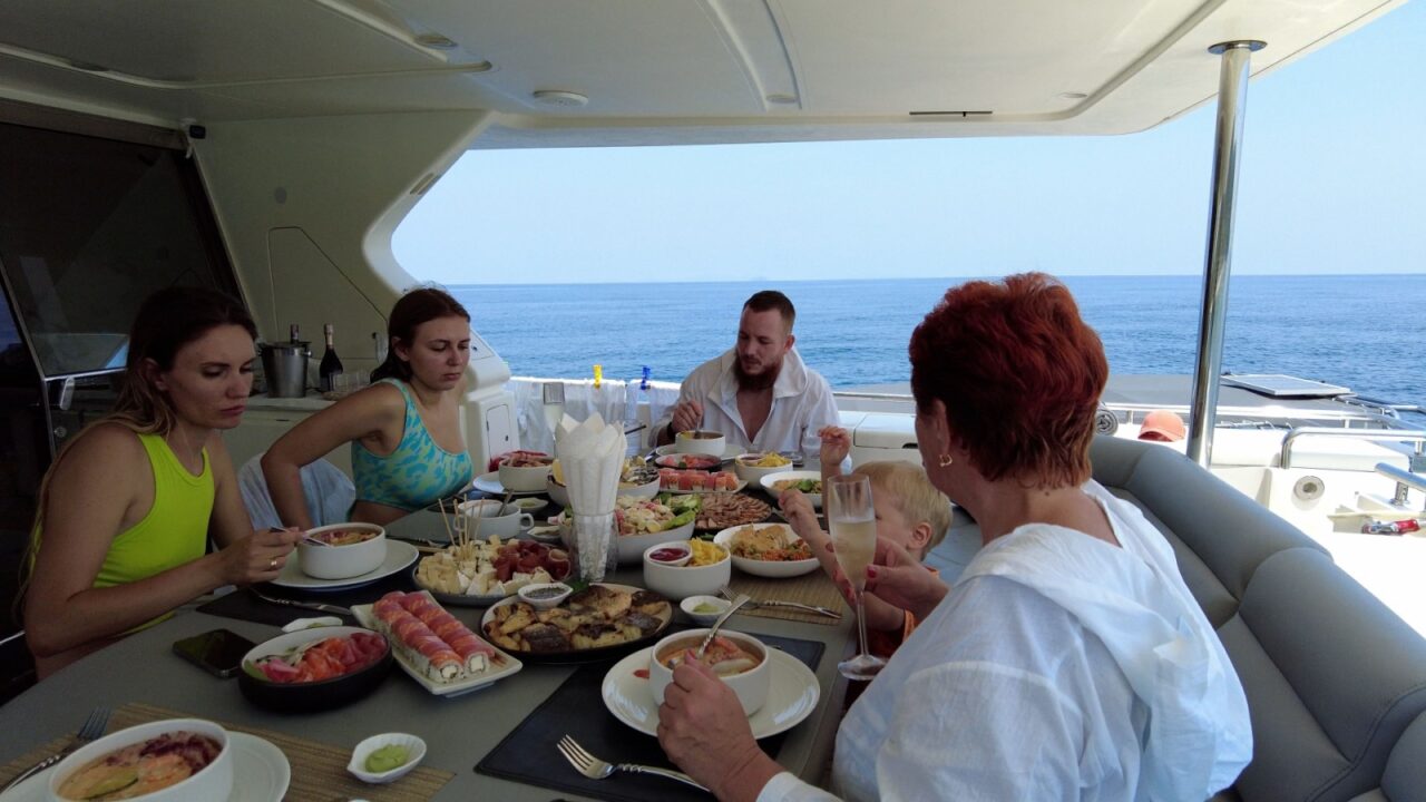 Phuket, Thailand, 30,September, 2023: Family lunch on private luxury yacht, tourists having lunch on yacht while island hopping