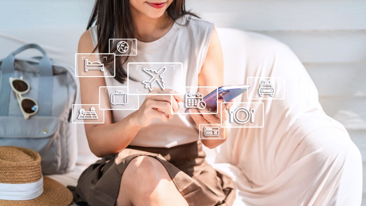 Young female using smartphone for planning a trip, flight booking and find travel information on vacation