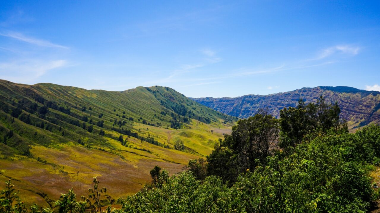 Vacationing in sunny weather by visiting mountainous areas with natural views and fresh, cool air.