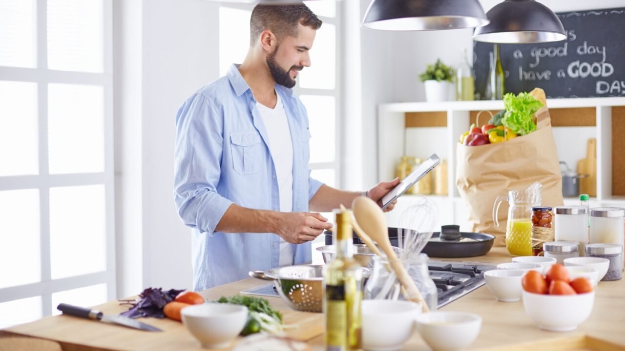 Smiling and confident chef standing in large kitchen