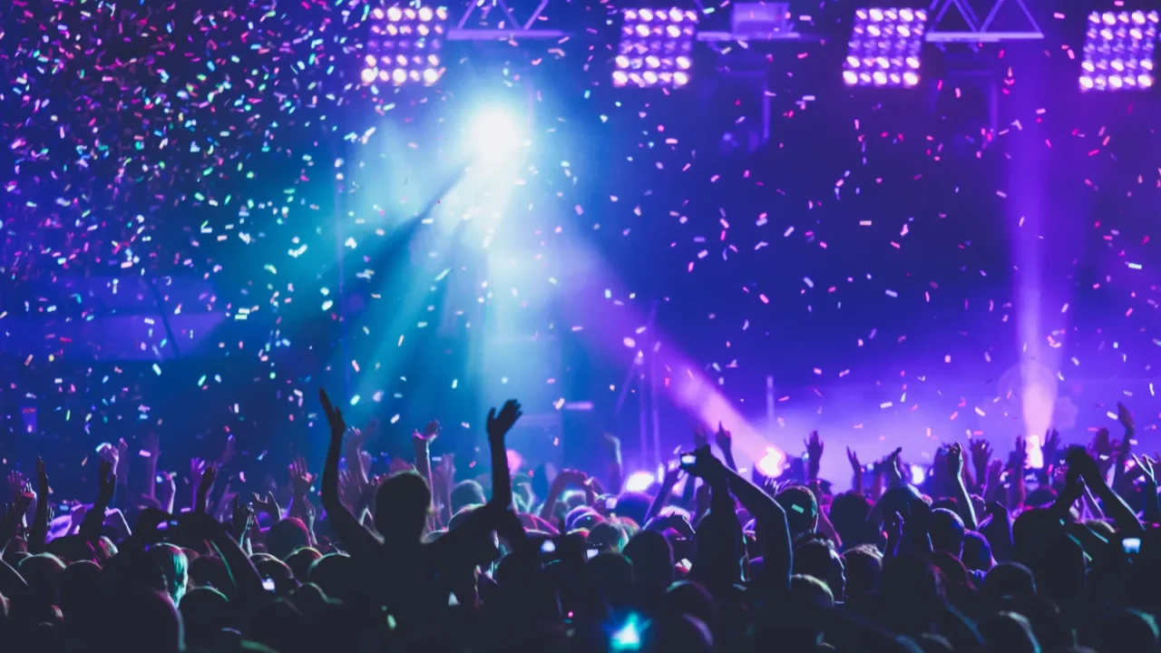 a crowded concert hall with scene stage lights rock show