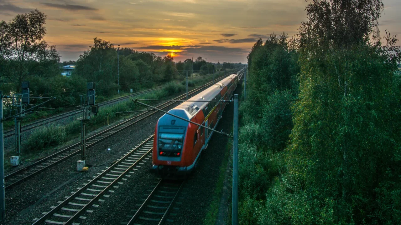 a moving train in red and a sunset