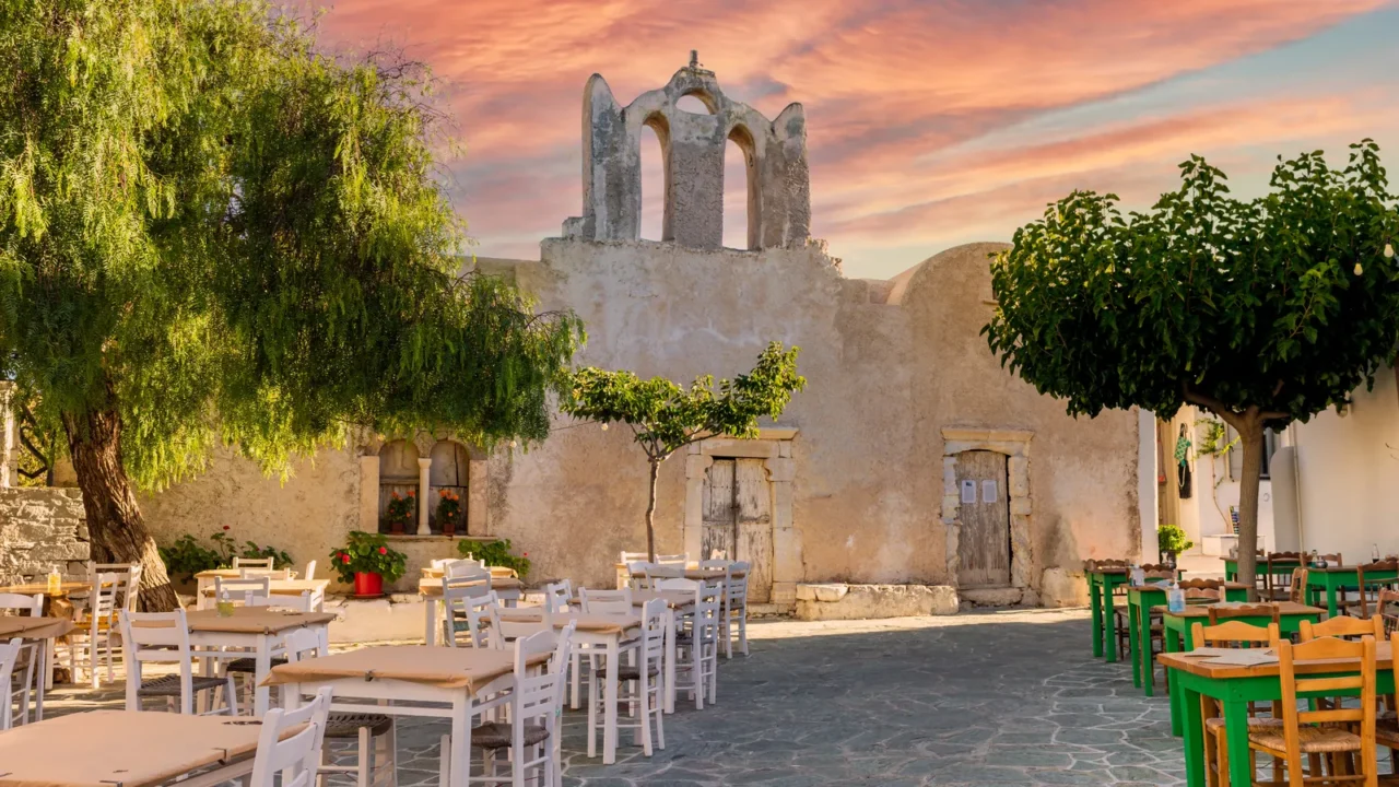 a square with restaurants and old church building in beautiful