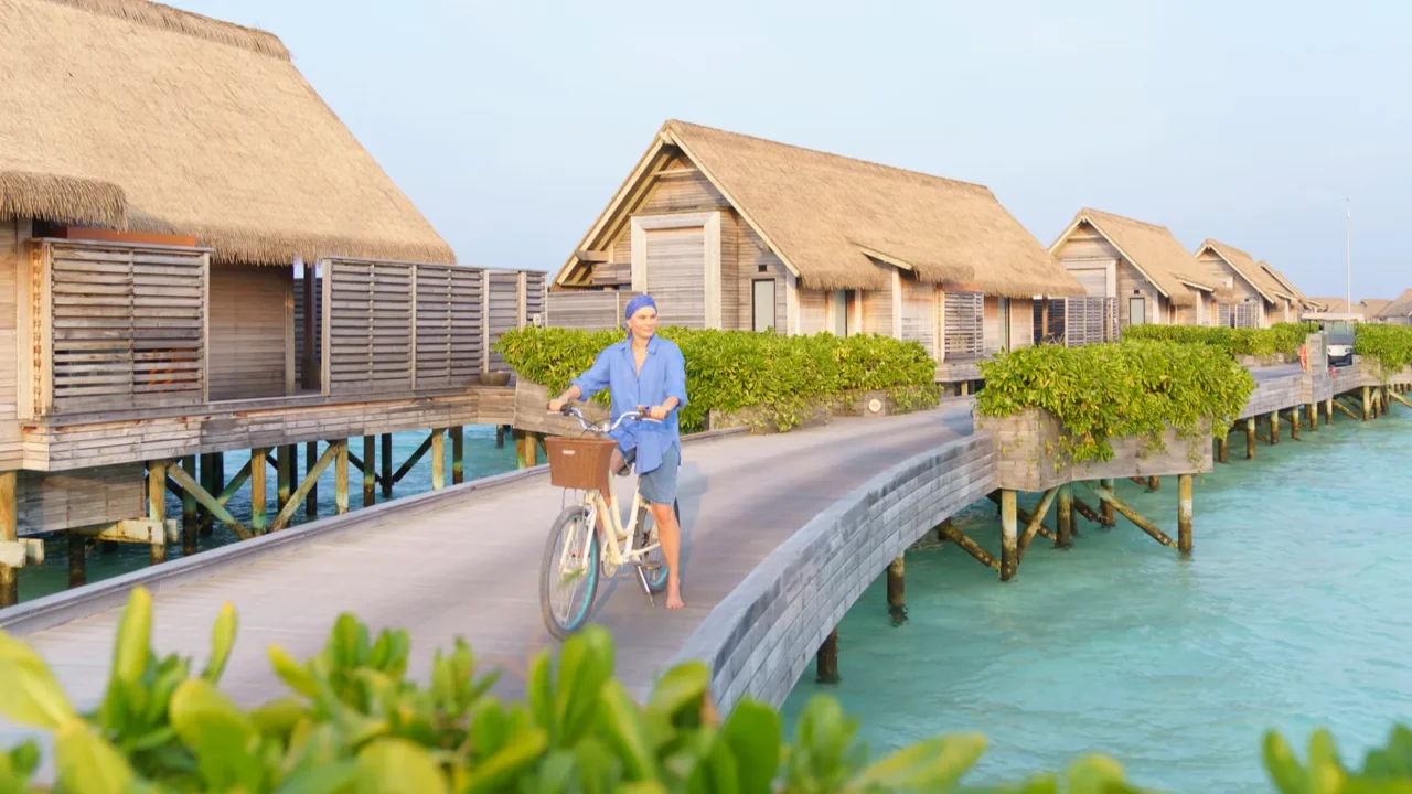 a woman on a bicycle on vacation in the maldives