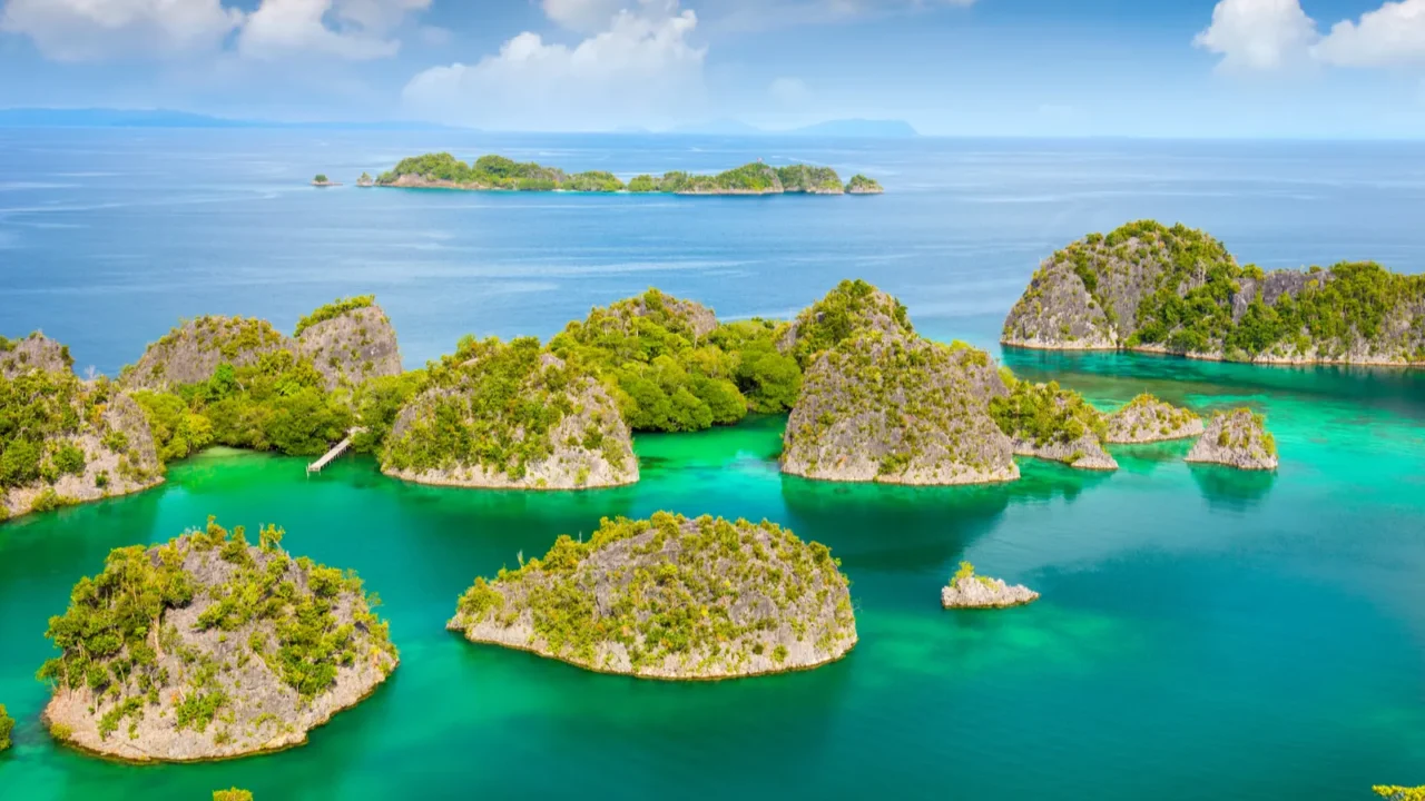 aerial view of small islands in turquoise sea with reef