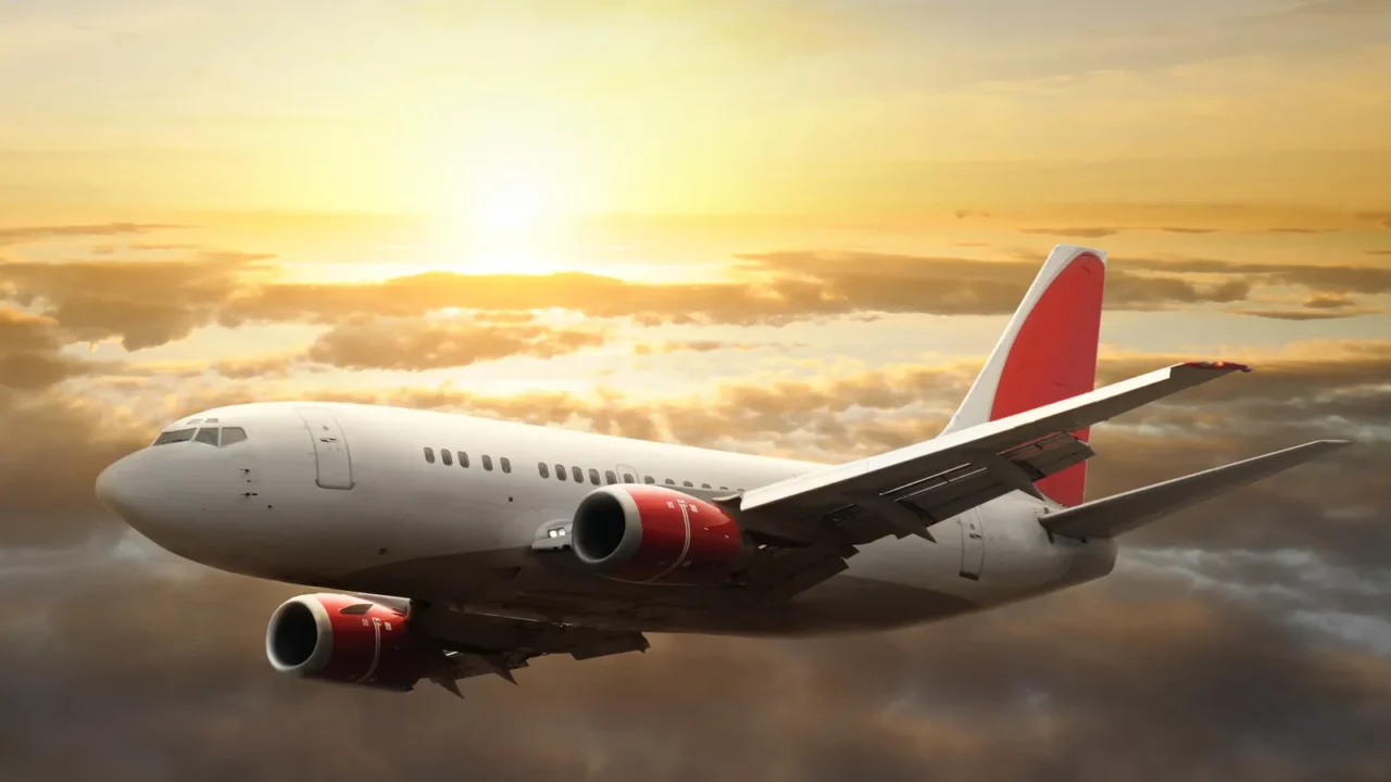 airplane in the sky at sunset