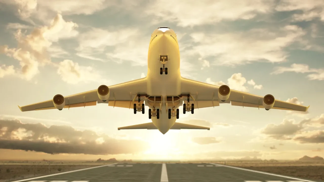 airplane taking off at sunset