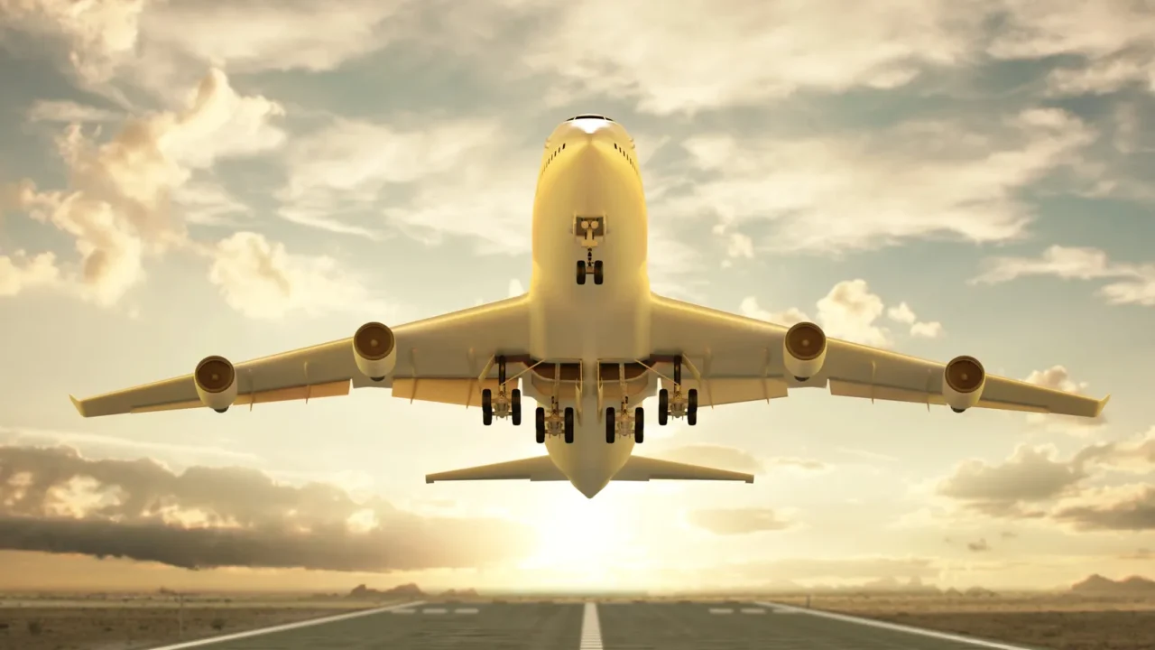 airplane taking off at sunset