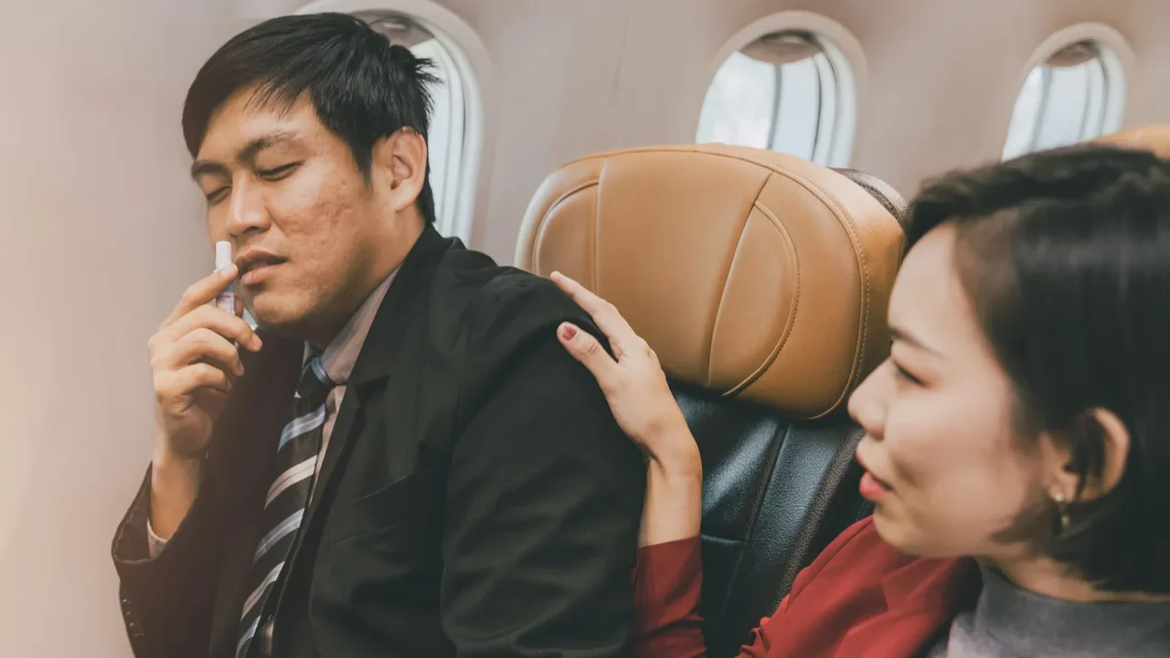 asian businessman male motion sick health problem during fly on