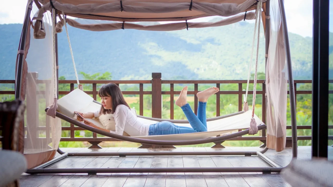 asian younger woman toothy smiling with happiness holding smart phone