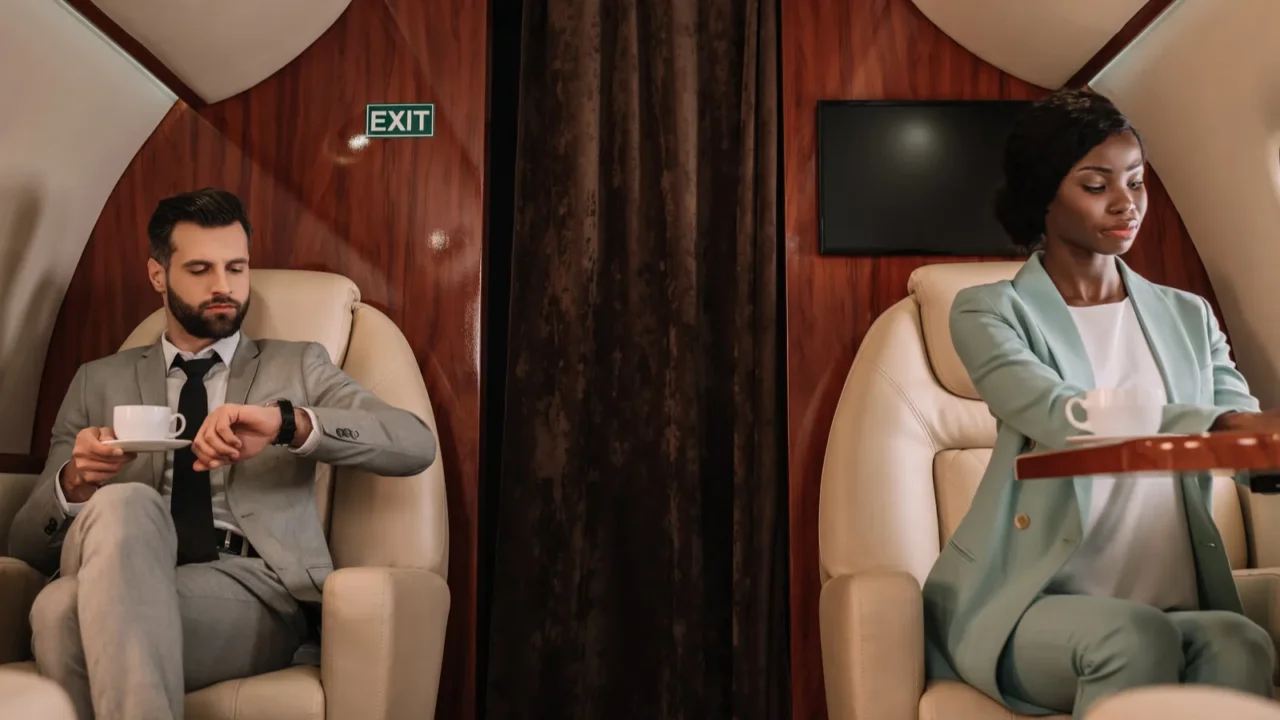 attentive african american businesswoman typing on laptop and businessman looking