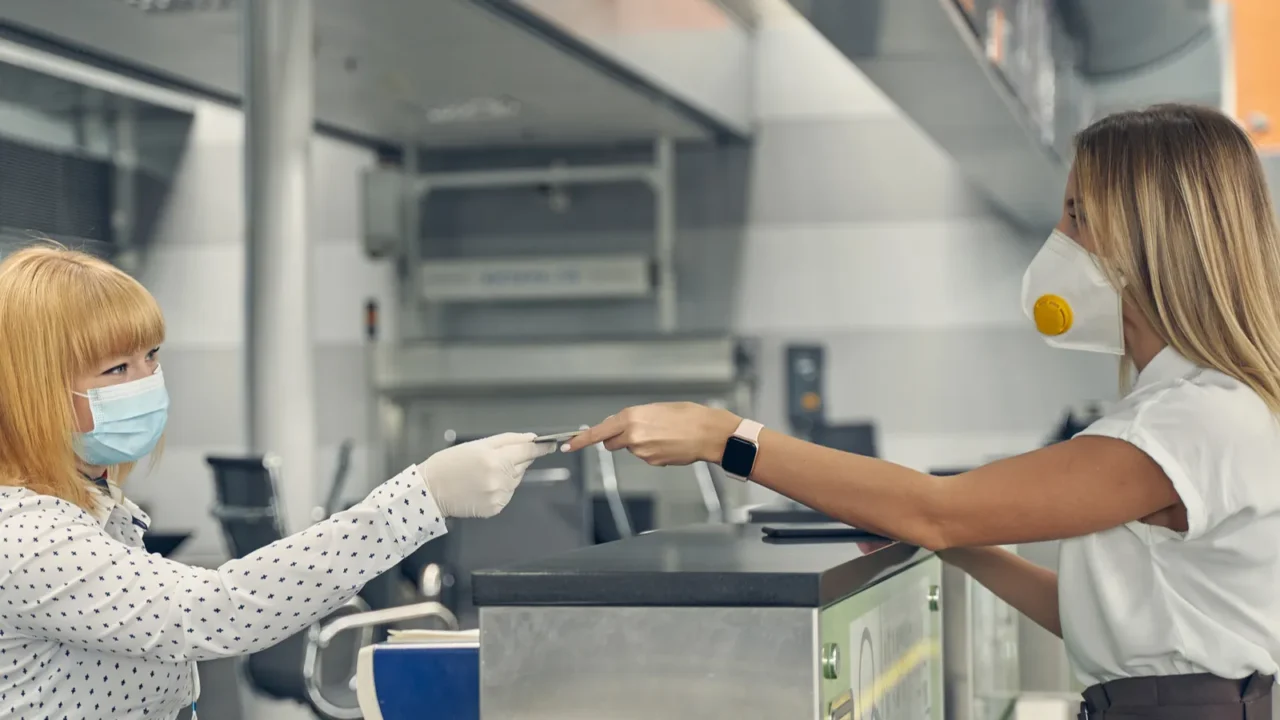 attentive blonde woman taking her boarding pass