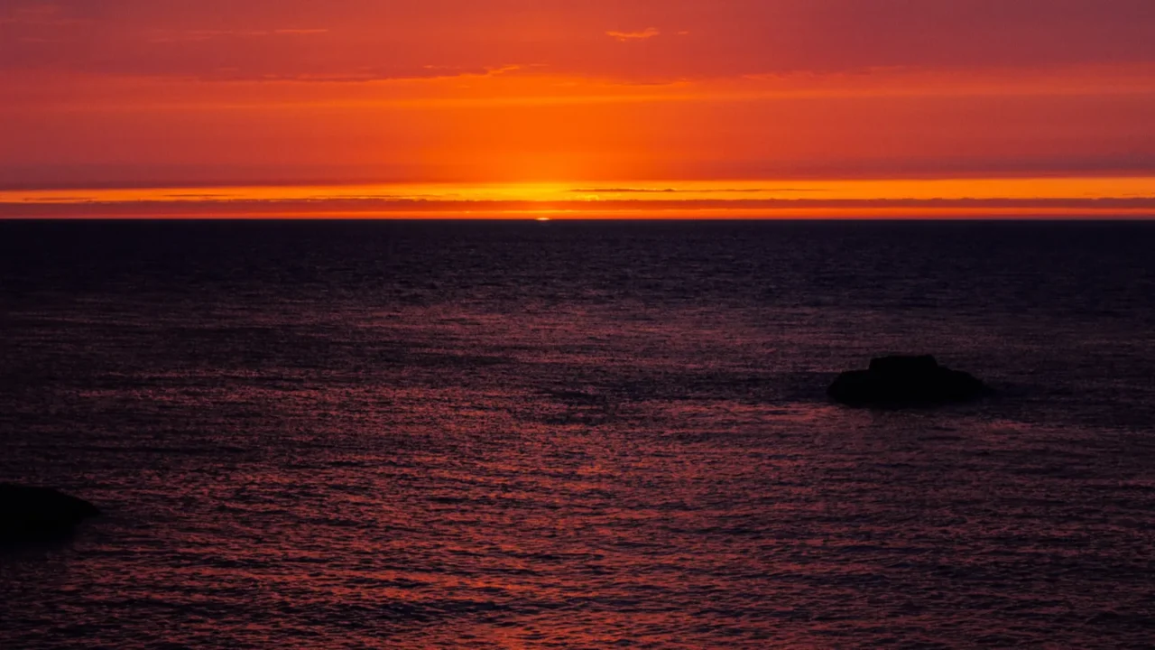background with red sunset over the sea etretat normandy france