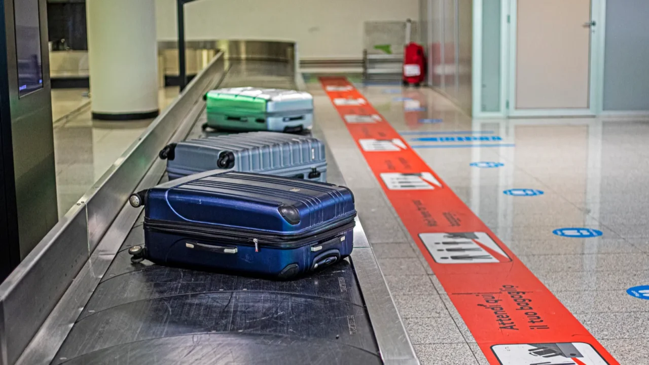 baggage conveyor with luggage in the airport lobby after arrival