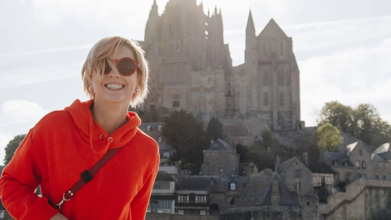 beautiful cheerful girl in red hoodie posing near saint michaels