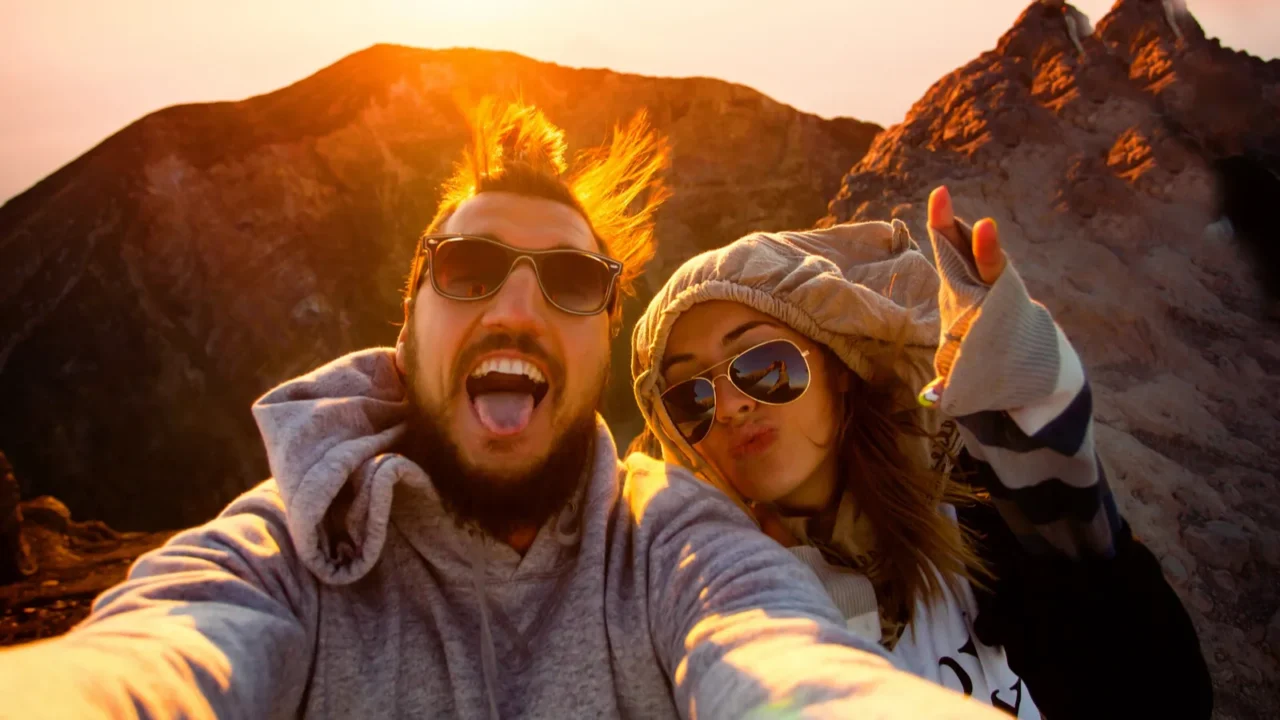 beautiful traveling couple on the top of the mountain