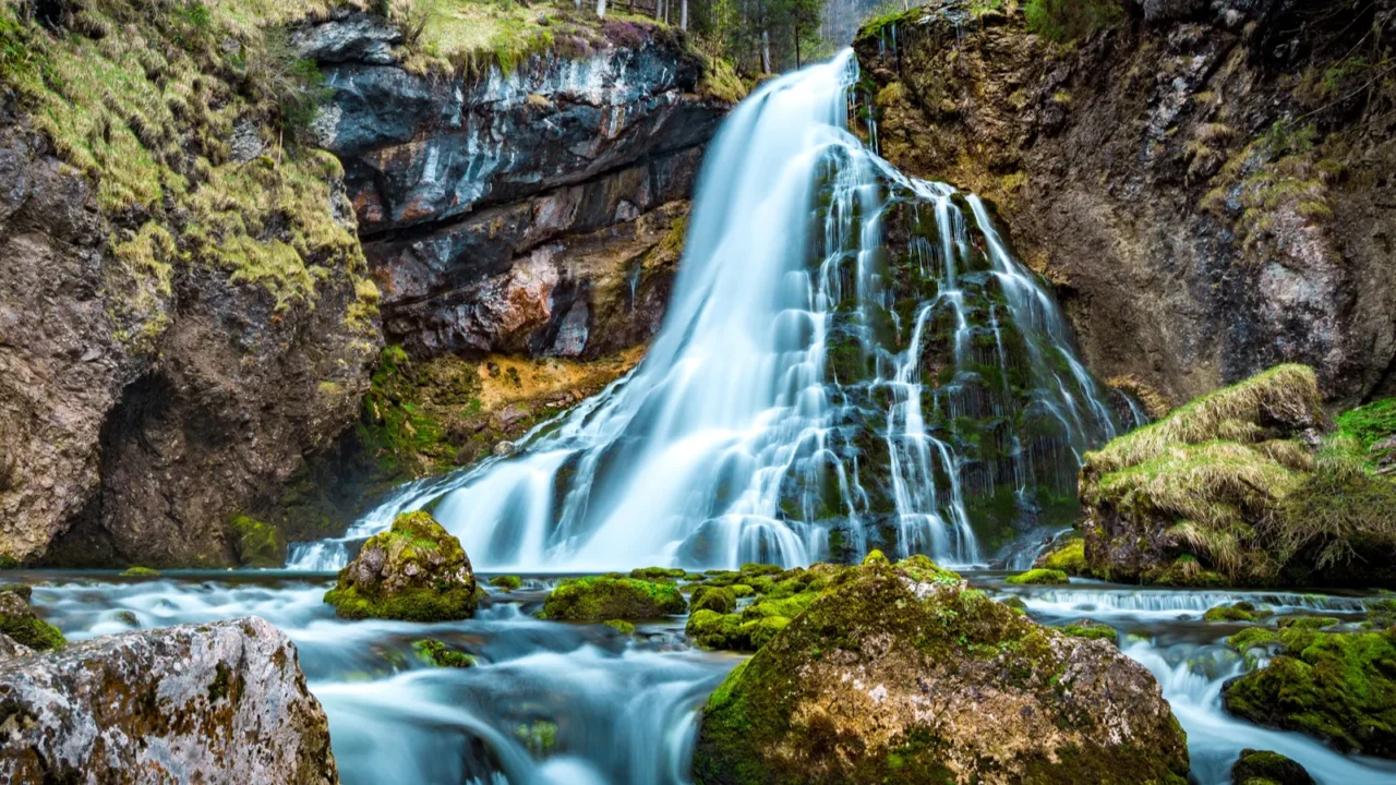 beautiful view of famous gollinger wasserfall with mossy rocks and