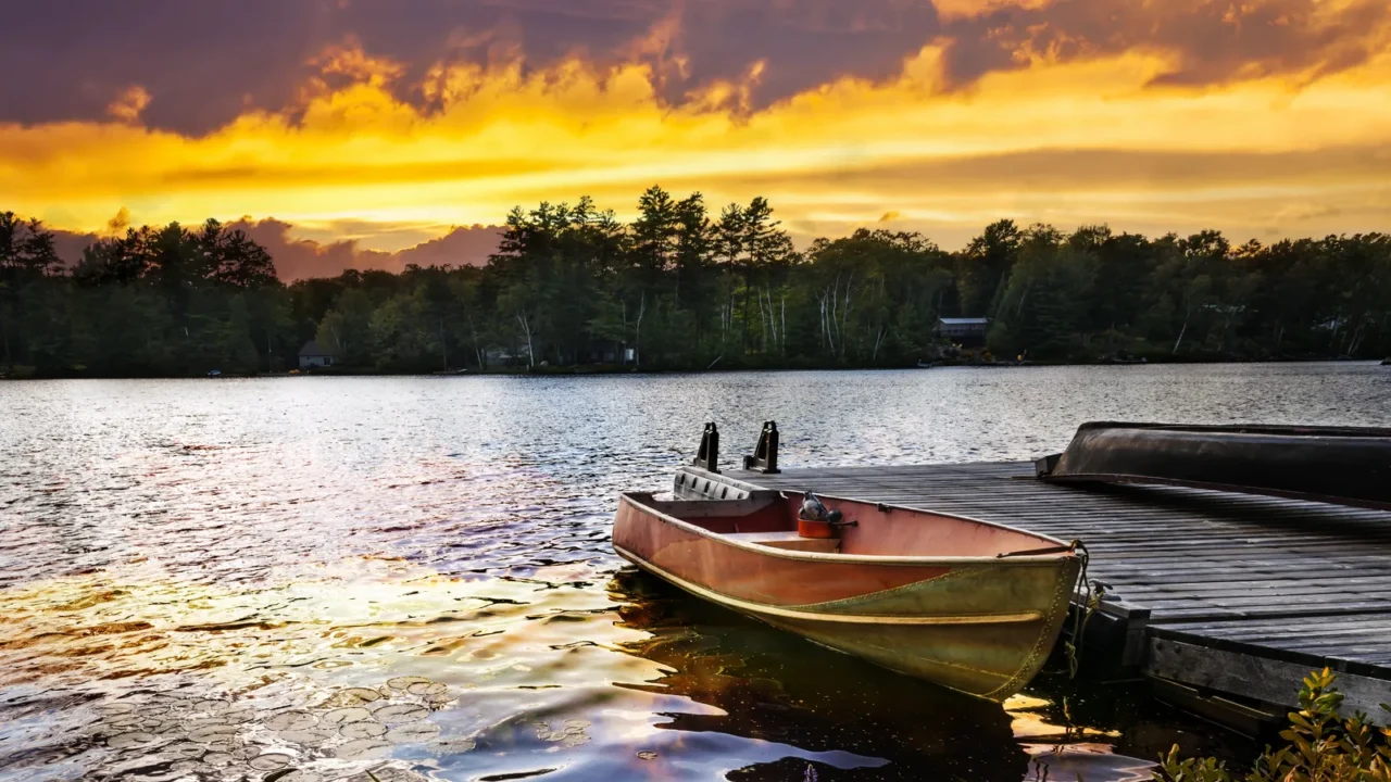 boat docked on lake at sunset