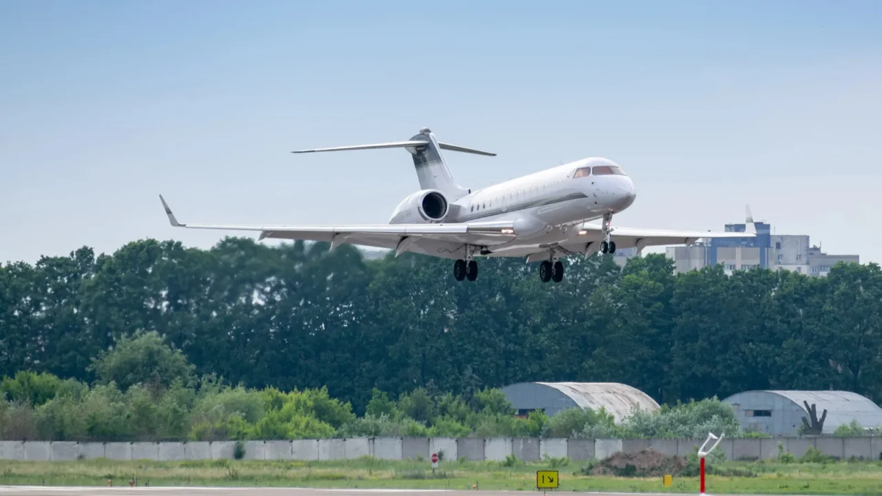 business jet on final approach before landing on the runway